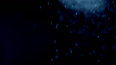 Soft Blue Dust Motion on Dark Background
