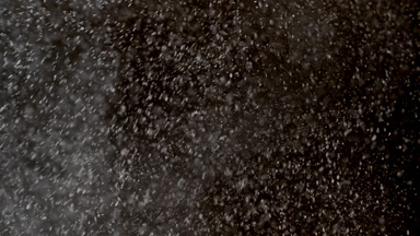 Floating White Powder Dust on Black Background