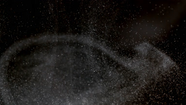 Floating White Dust Particles on a Dark Background