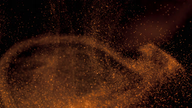 Floating Yellow Powder Dust on a Dark Backdrop