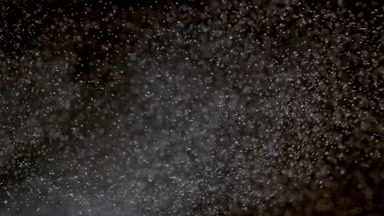 Soft White Dust Motion on Dark Backdrop
