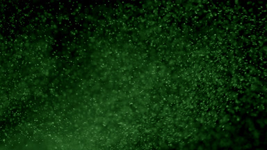 Scattered Green Dust Particles in Air on Black