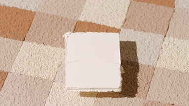 Beige Pressed Powder Over Brown Mosaic Background