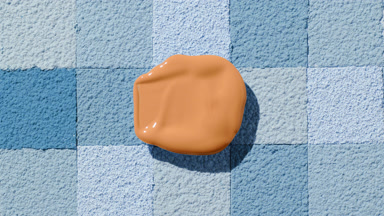 Beige Foundation Blob with Shadow on Blue Mosaic Surface