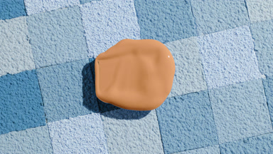 Beige Foundation Blob with Shadow on Blue Powder Surface