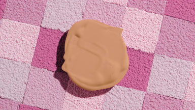 Extreme Close-Up of Beige Foundation on Pink Powder