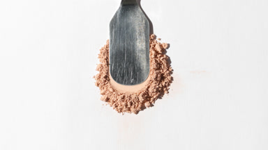 Extreme Close-Up of Beige Powder on Grey