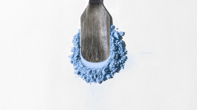 Close-Up of Blue Loose Powder on Grey Background