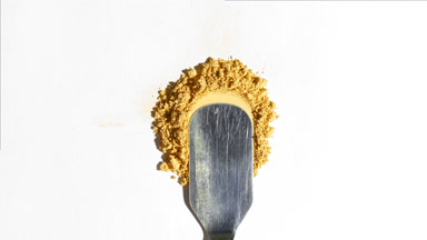 Yellow Loose Powder Stack on Pale Grey Background