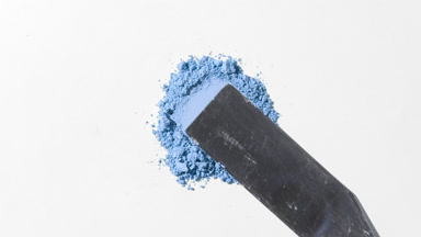 Close-Up of Blue Powder on Soft Grey Base