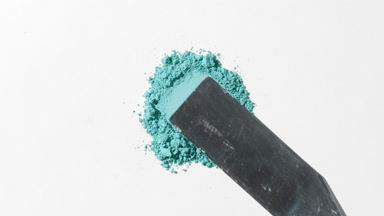 Cyan Loose Powder Close-Up on Light Grey Surface