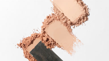 Three Beige Powder Heaps Smudged on Light Grey Background