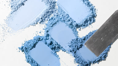 Overhead View of Chaotic Blue Powder Smears on Grey Background