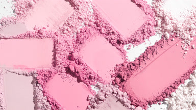 Extreme Close-Up of Random Pink Powder Smears on Grey Surface