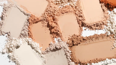 Ultra-Close Shot of Beige Powder Smears on Dim Grey Background