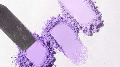 Macro Close-Up of Violet Powder on Light Gray Surface