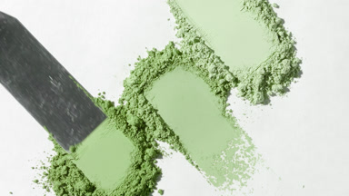 Extreme Close-Up of Pale Green Powder on Light Gray