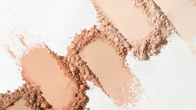 Beige Powder Smears in Dynamic Light on White Surface