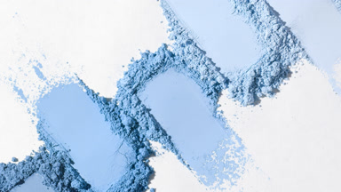 Blue Powder Piles on Light Gray with Moving Shadows