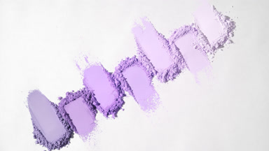 Top View of Seven Violet Powder Smears on Pale Gray Canvas