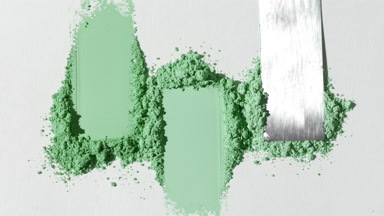 Green Powder Heaps Spread on Light Gray Backdrop