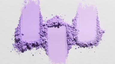 Ultra-Close Shot of Violet Powder Smudges on Light Grey
