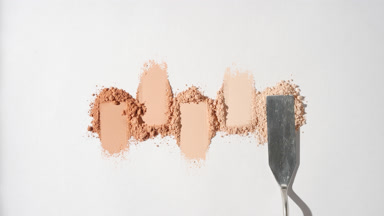Top Perspective of Beige Powder Heaps on Pale Gray