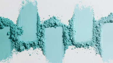 Cyan Loose Powder Streaks on Subtle Grey Surface
