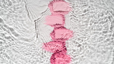 Slow-Motion Water Over Pink Powder Heaps