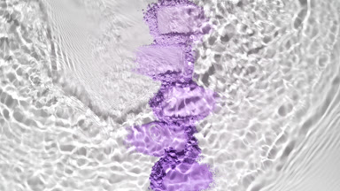 Slow-Motion Water Flow Over Violet Powder Heaps