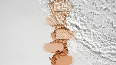 Slow-Motion Water Over Beige Powder Heaps