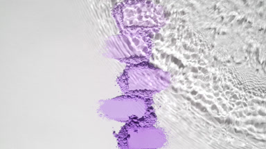 Slow-Motion Water Flow Over Violet Powder Heaps