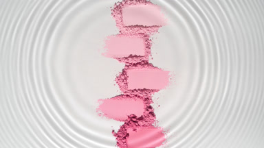 Water Droplet Creating Circles Over Pink Powder