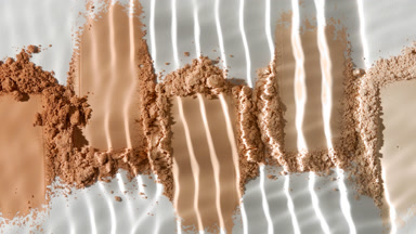 Slow Motion Water Stream Over Beige Powder Heaps