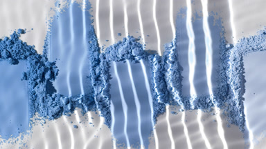 Close-Up Water Stream on Blue Powder Heaps