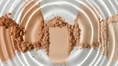 Water Droplet Creating Circles Over Beige Powder Heaps