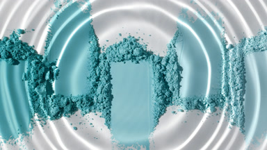 Droplet Making Waves Over Cyan Powder Heaps