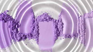 Water Droplet Generating Waves Over Violet Powder Heaps