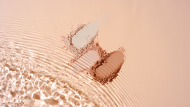 Slow-Motion Capture of Beige Powder on Tan Backdrop