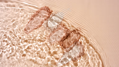 Water Splash Over Beige Powder for Creative Ad