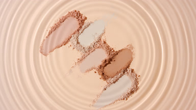 Concentric Circles from Water Droplet on Beige Powder