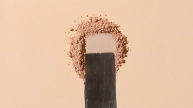 Close-Up of Beige Powder on Light Grey Background