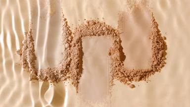 Slow Motion Water Splashing on Beige Powder Heaps