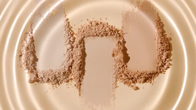 Water Droplet Patterns on Beige Powder Heaps