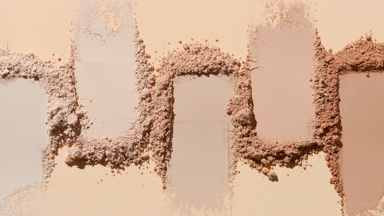Macro Close-Up of Beige Powder Smears with Dynamic Light