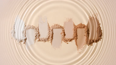 Water Droplet Creating Circles Over Beige Powder Smears