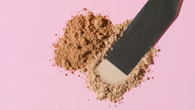 Beige Loose Powder Close-Up on Baby Pink Background