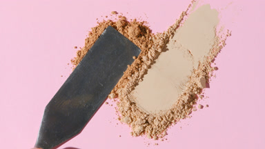 Beige Powder Heaps Close-Up on Pastel Pink Surface
