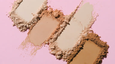 Extreme Close-Up of Beige to Brown Powder on Pink Backdrop