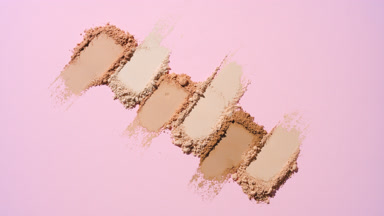 Top-Down View of Beige to Brown Powder Smears on Soft Pink